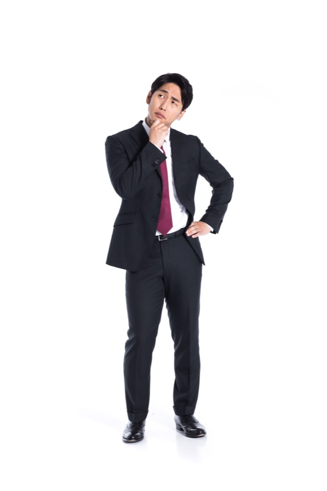 ノートパソコンで副業について調べる会社員男性